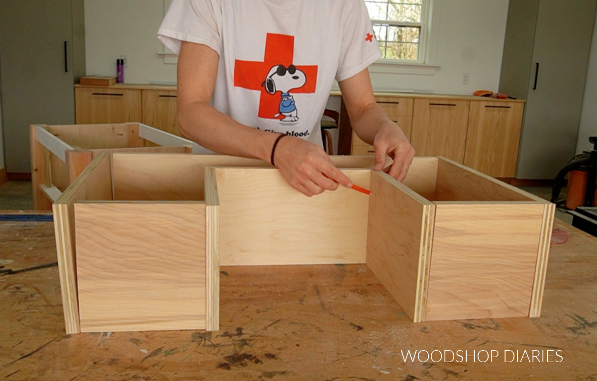 Shara Woodshop Diaries laying out drawer box pieces on workbench