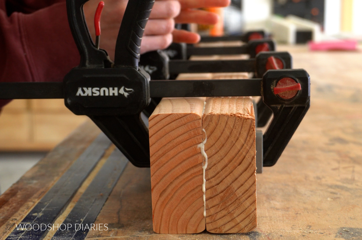 Clamping glued together 2x4 boards to make leg posts for bathroom vanity