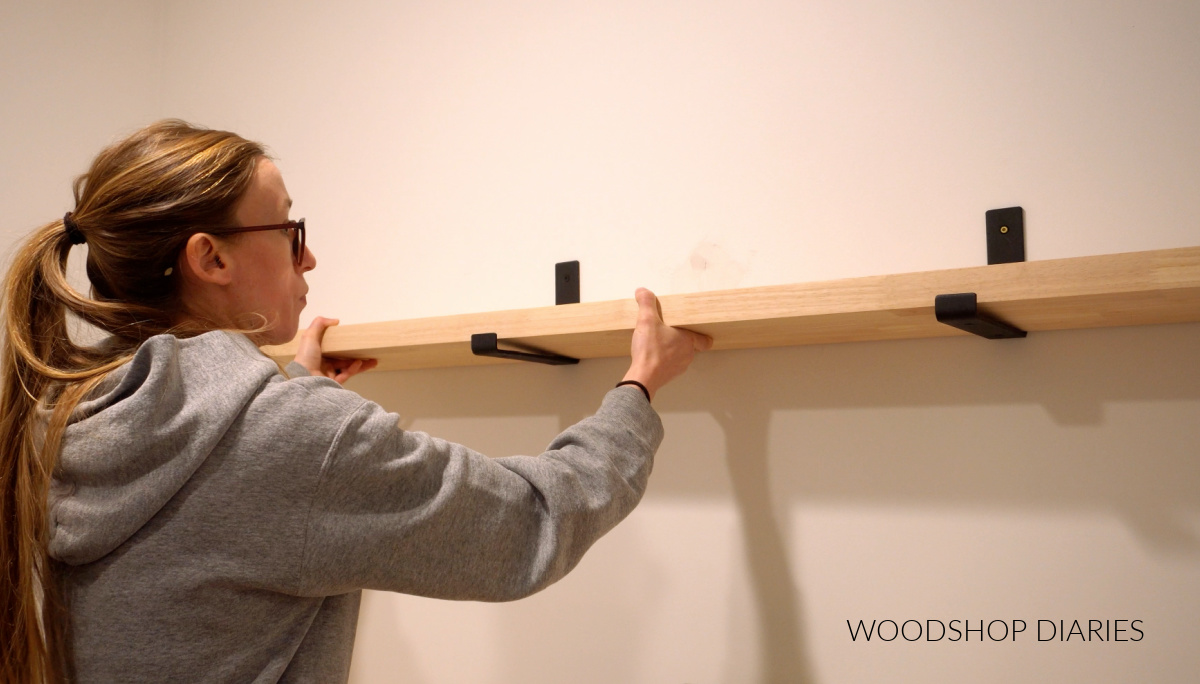 Shara Woodshop Diaries installing shelf on J brackets in laundry room