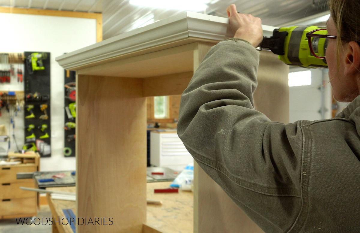 Shara Woodshop Diaries installing crown molding around top of bathroom cabinet