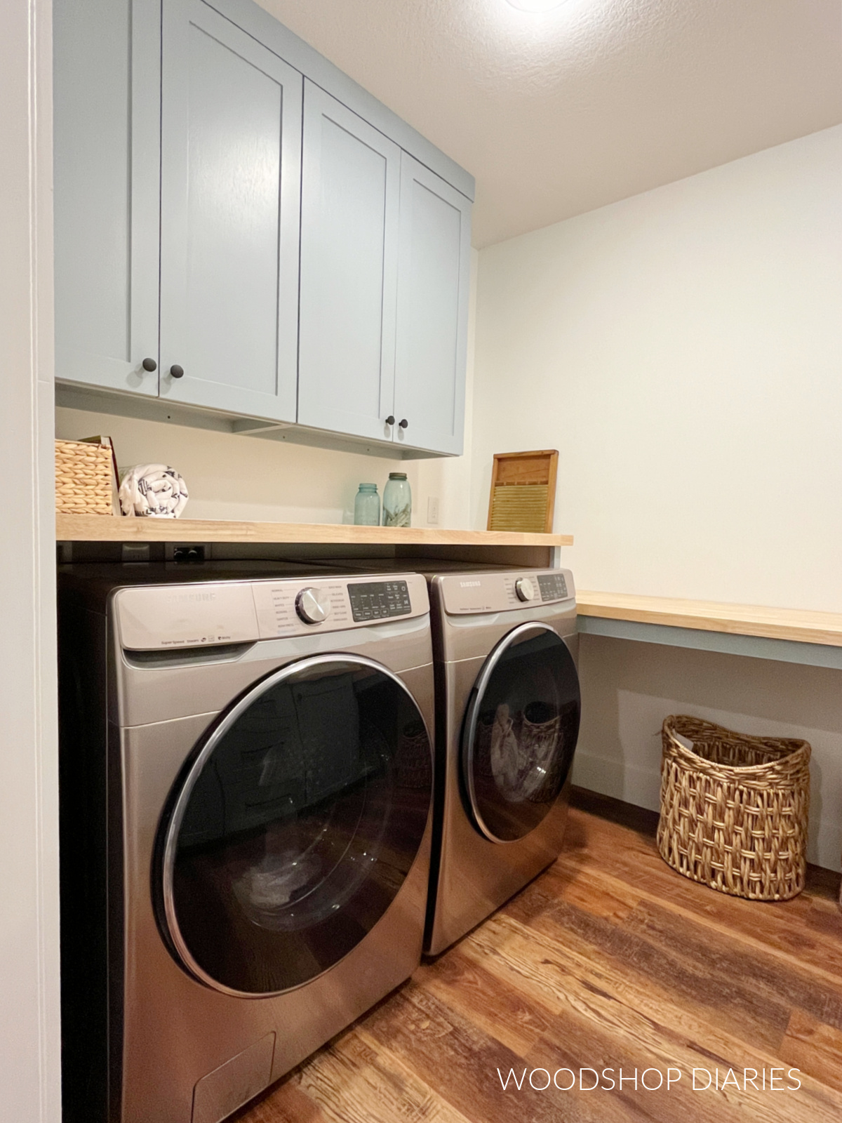 Washer and dryer with countertop and wall cabinets above it