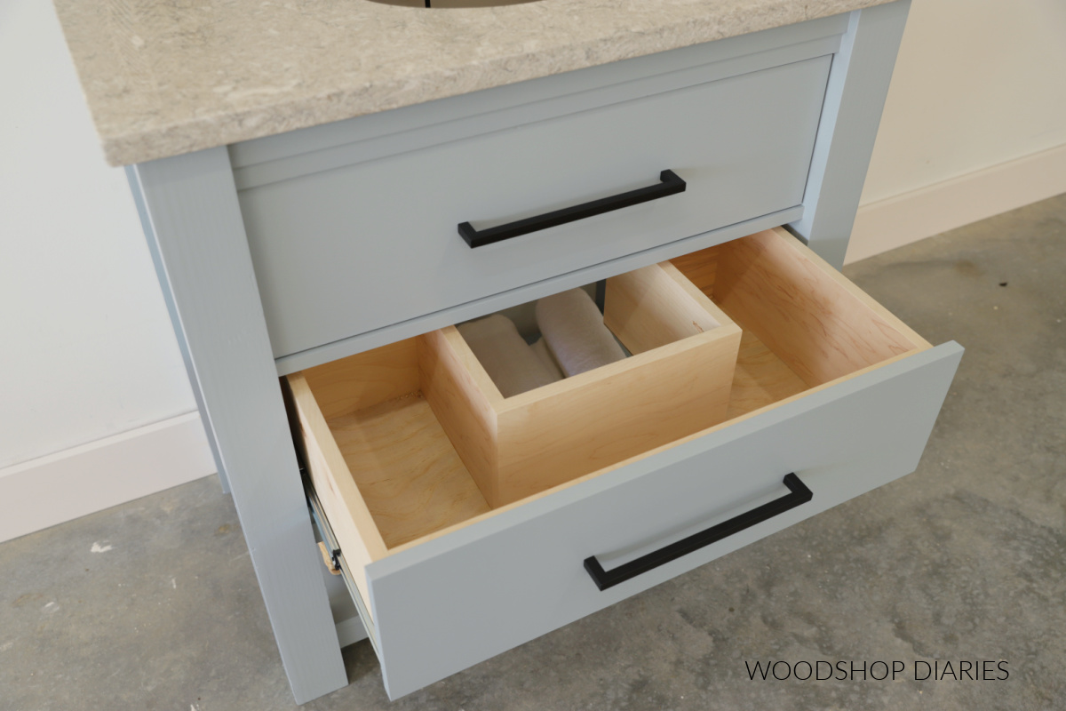 Completed bathroom vanity with large bottom drawer open