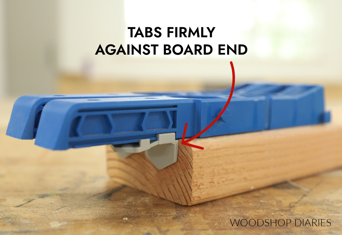 Kreg XL jig placed on end of board with tabs against edge