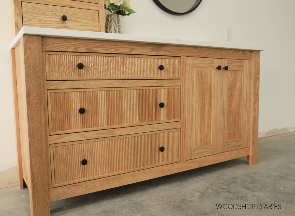 Completed red oak vanity base with large drawers and reeded drawer fronts