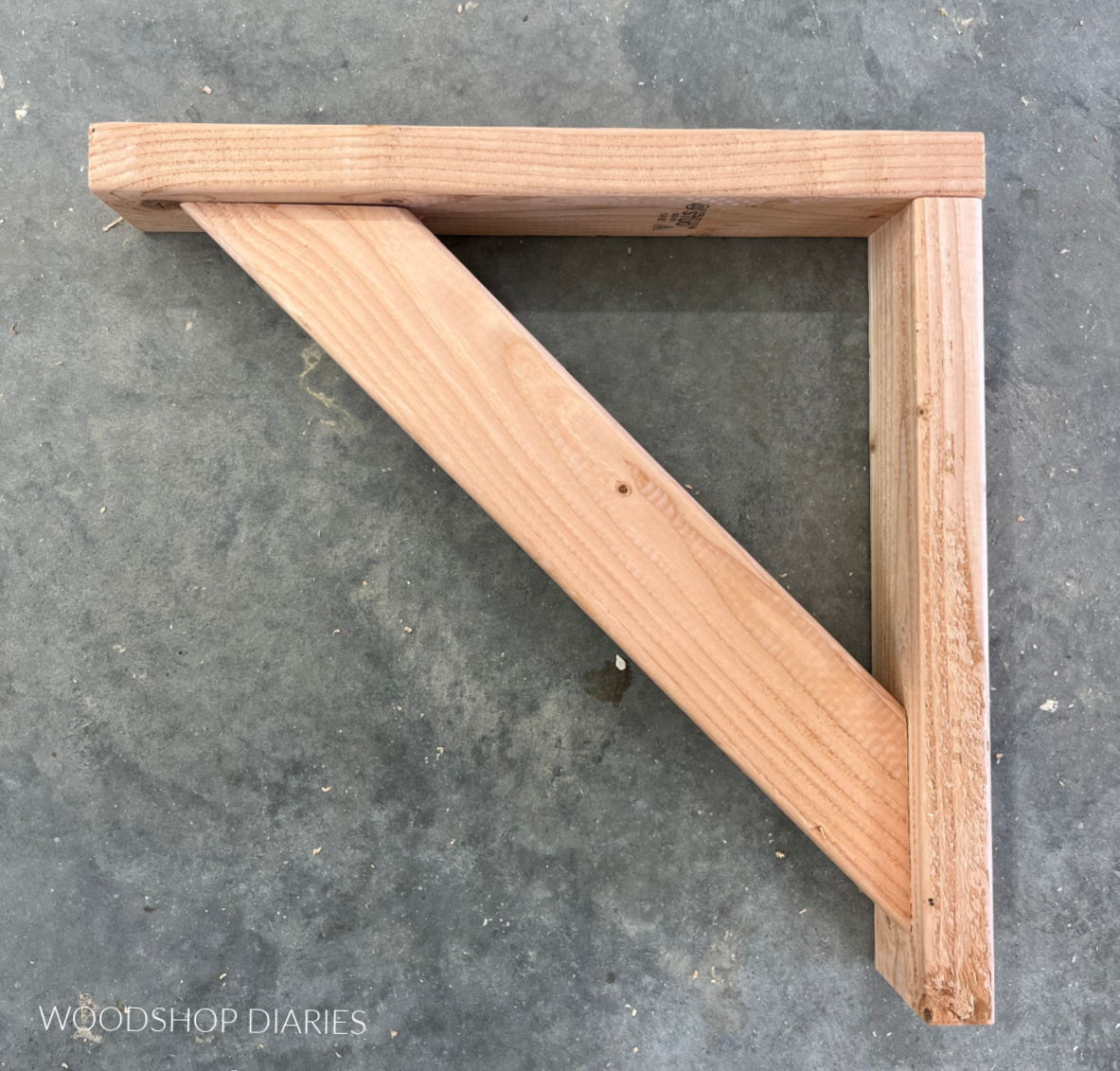 Triangle shaped shelf support assembled on concrete floor