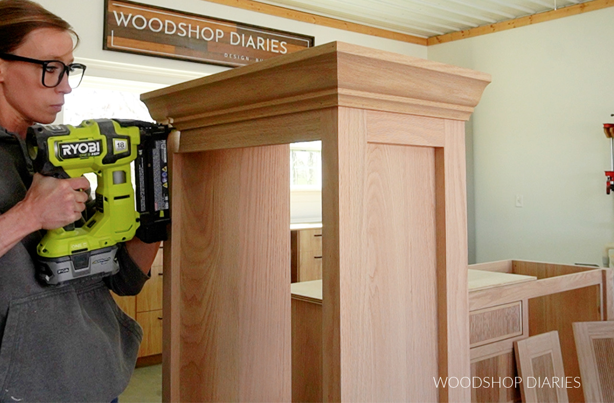 Shara Woodshop Diaries nailing crown molding around top of bathroom cabinet