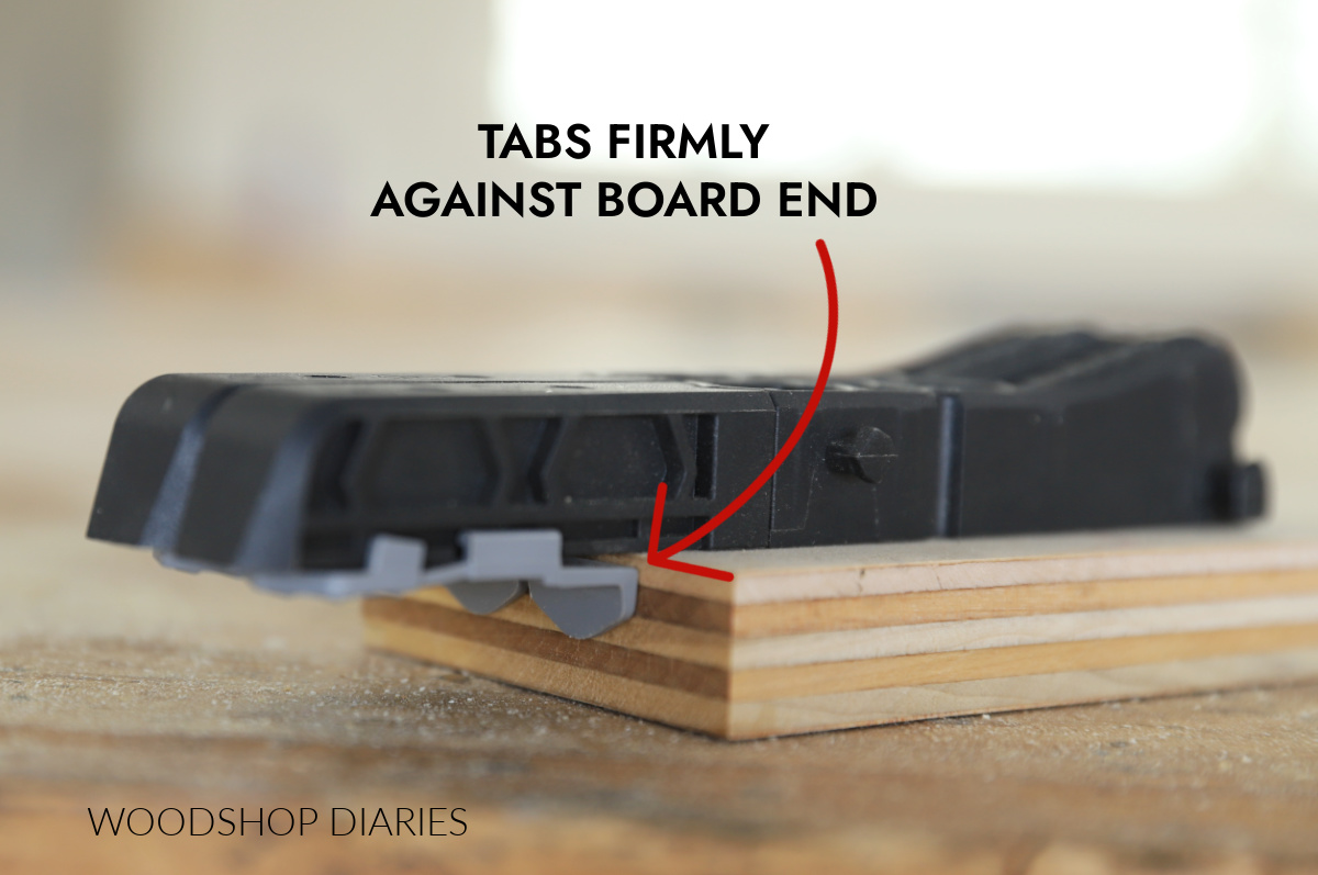 Kreg Micro Pocket Hole Jig placed on end of board with tabs against edge