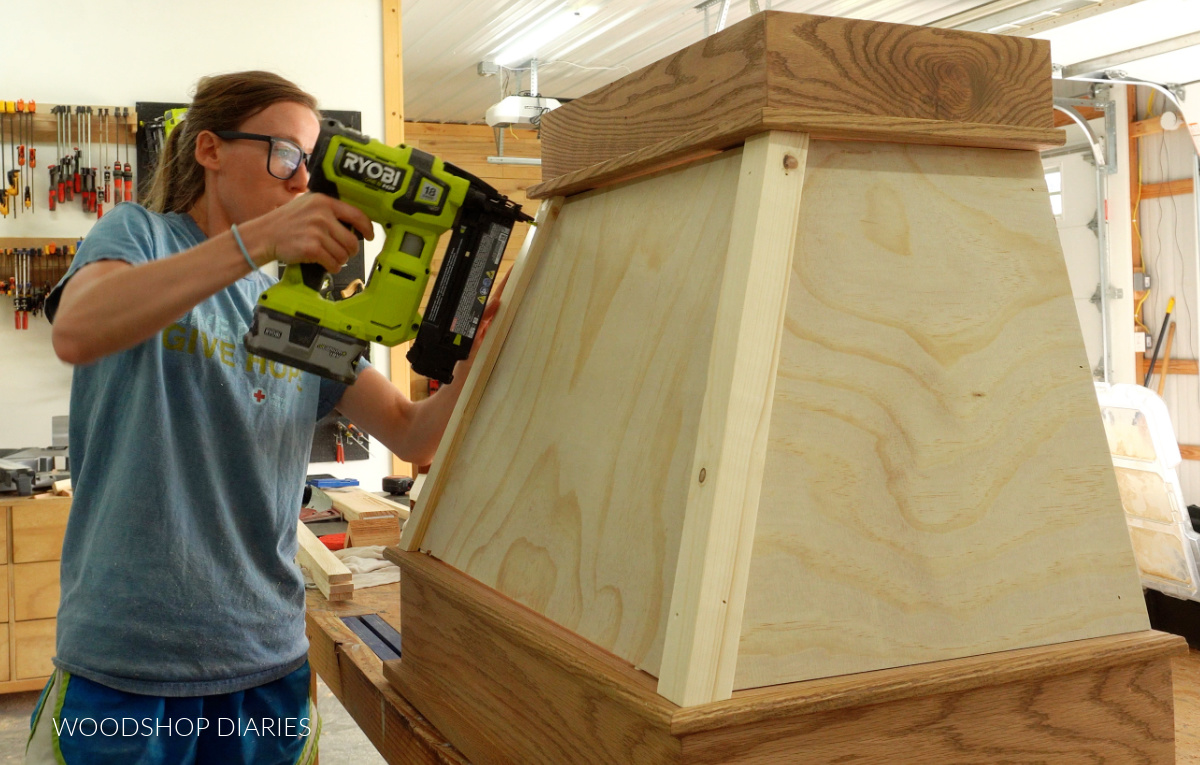 Shara Woodshop Diaries nailing corner trim onto range hood cover