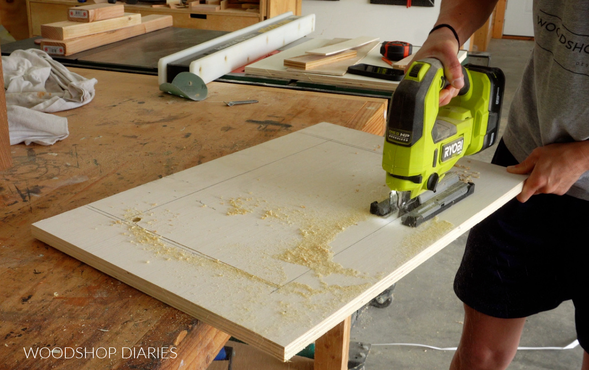 using a jig saw to cut out bottom panel to fit around fan