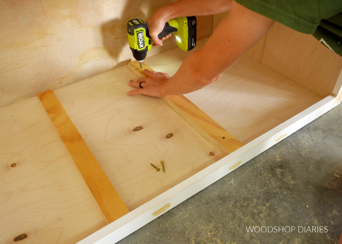 Installing spacer blocks for pull out drawer shelves in pantry cabinet