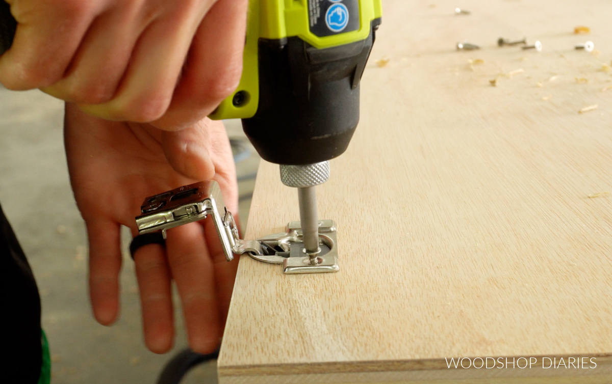 Close up of installing concealed hinge onto cabinet door