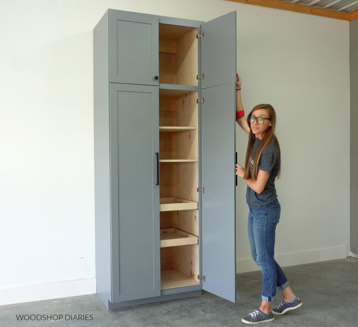 Shara Woodshop Diaries opening pantry cabinet doors showing adjustable shelves and pull out drawers inside
