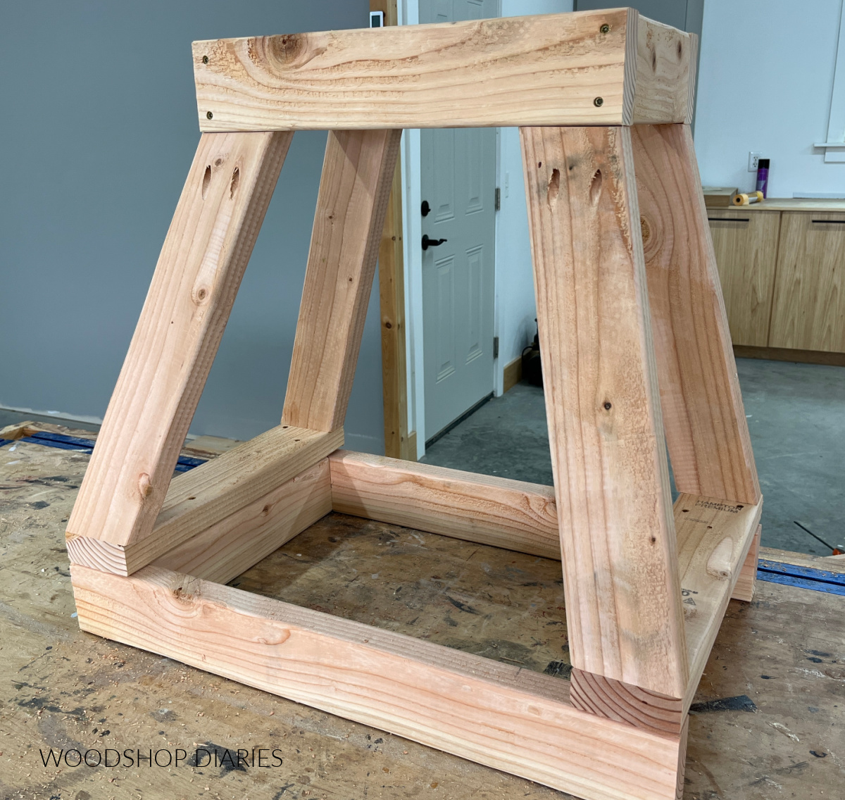 DIY range hood cover frame assembled from 2x4s on workbench