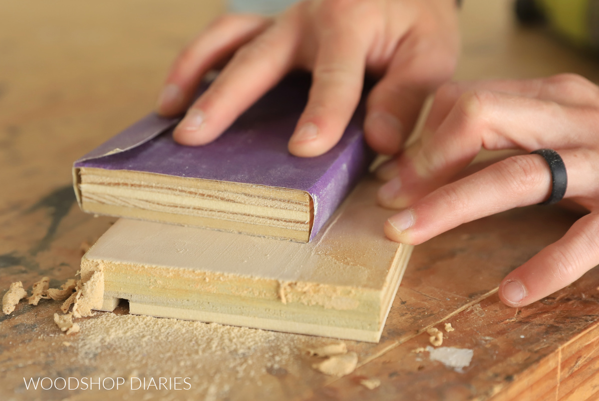 Close up of sanding puttied board end to repair tear out