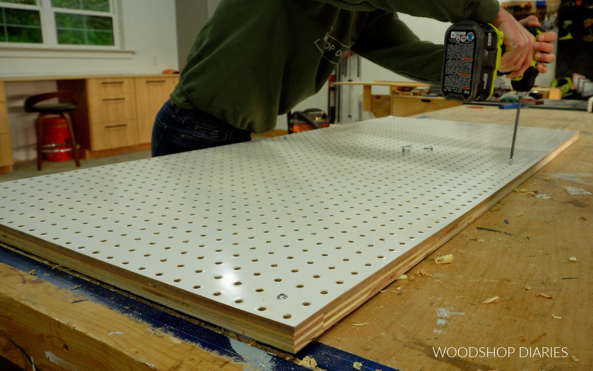 Screwing pegboard panel to plywood frame