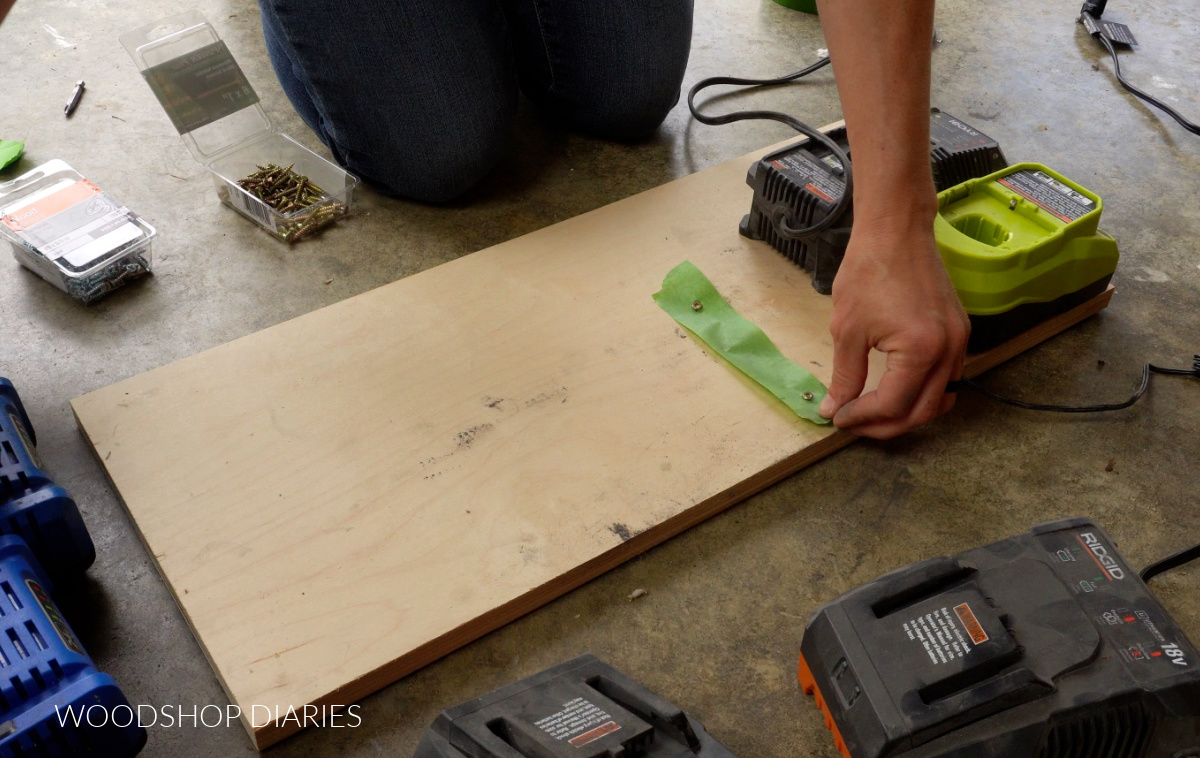 Screws through painters tape to mount battery charger