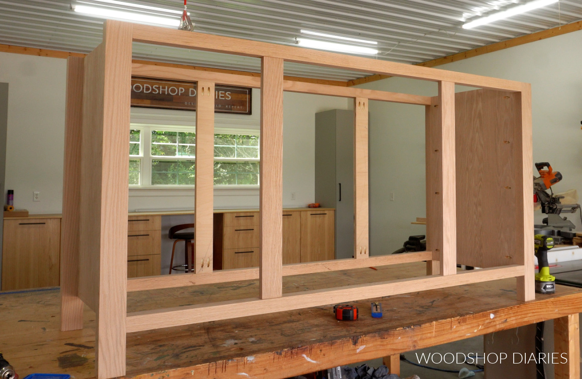 Dresser frame with four dividers installed to separate left, center, and right sections