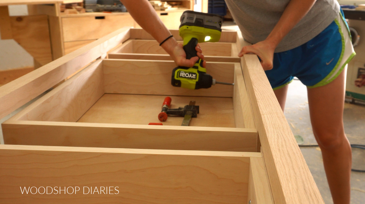 Shara Woodshop Diaries installing drawer fronts onto drawer boxes with screws from the inside