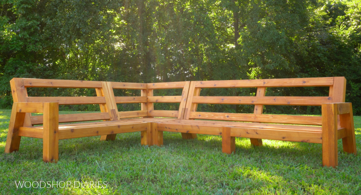 Three piece DIY modular sectional sofa frame pieced together in yard without cushions