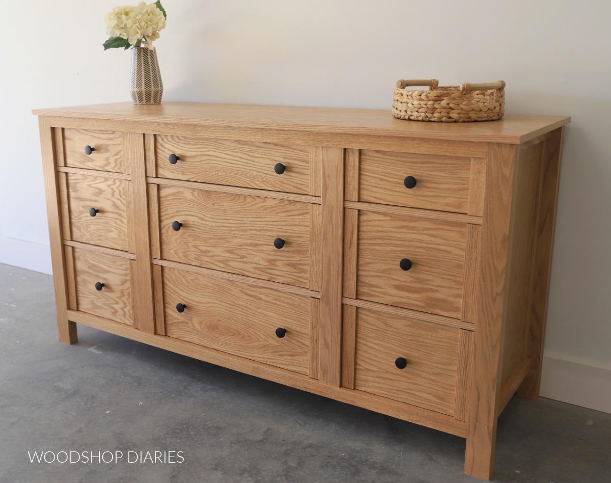 9 drawer dresser built from red oak lumber finished in Minwax Weathered Oak with black knobs against white wall