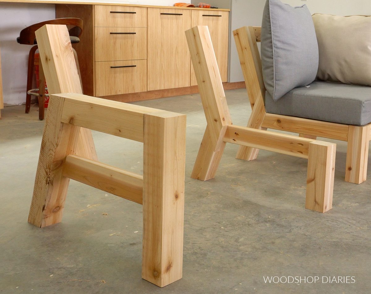 Left side of sectional side frames set out in workshop--arm rest side on left