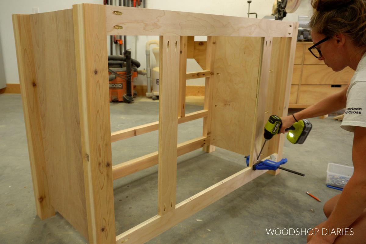 Shara Woodshop Diaries installing back supports to cabinet