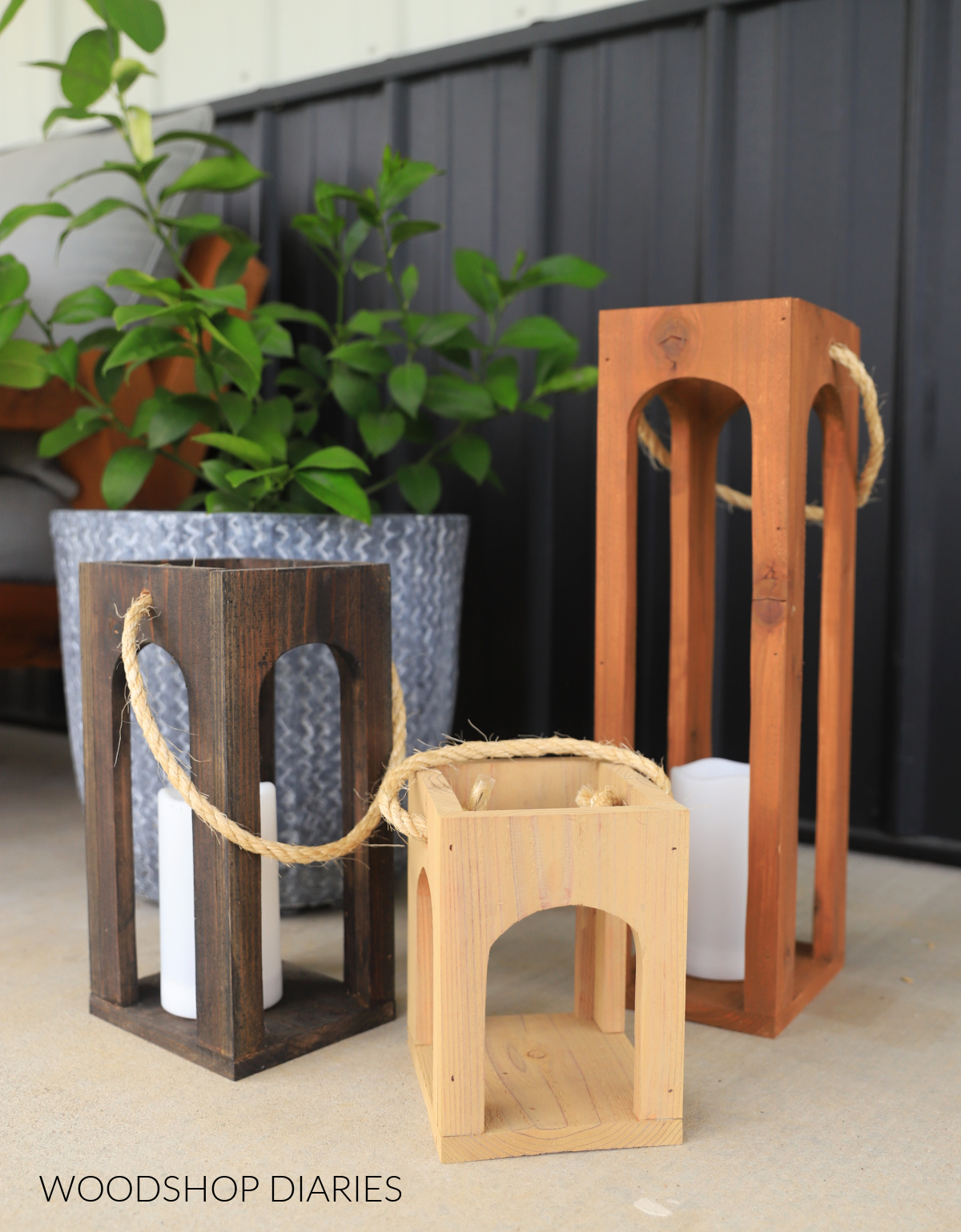 Three arched sided wooden lanterns on porch--all stained a different color