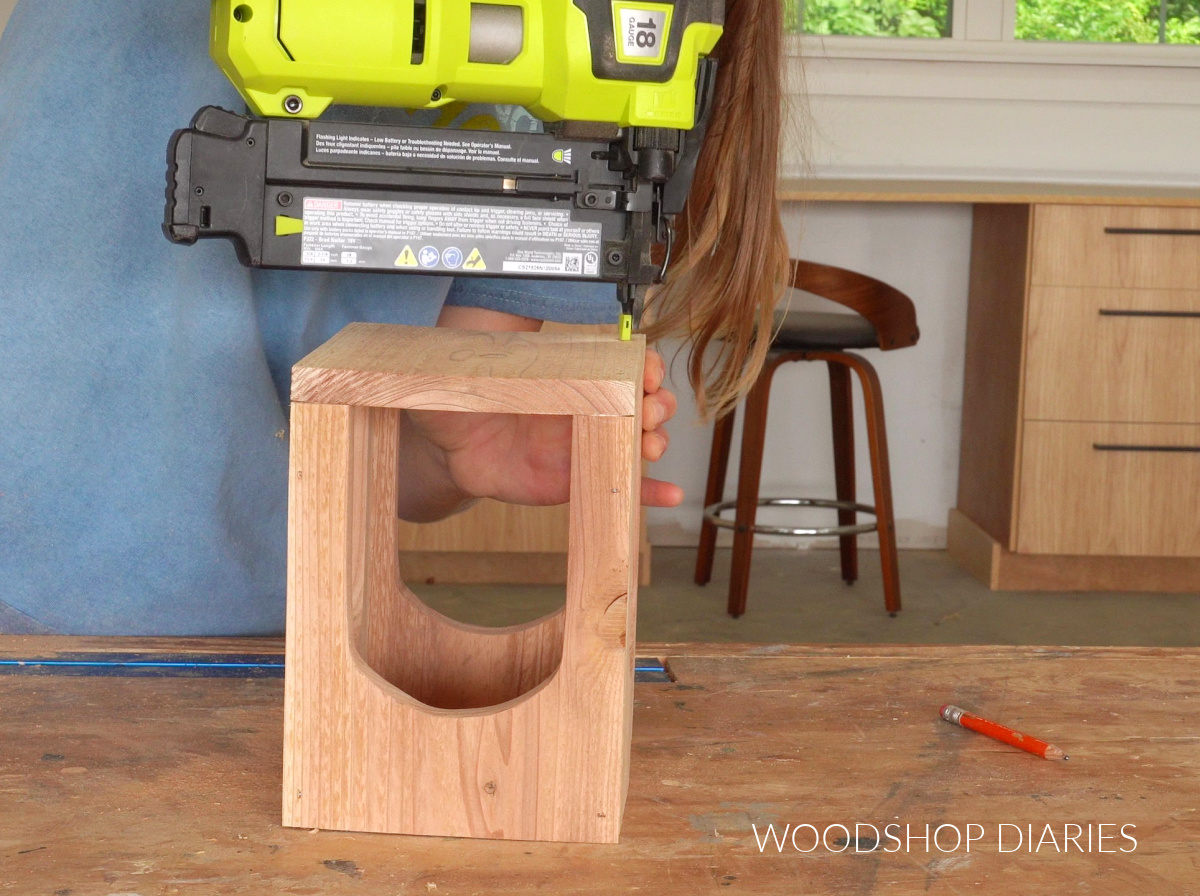 Shara Woodshop Diaries brad nailing bottom onto arched wooden lantern