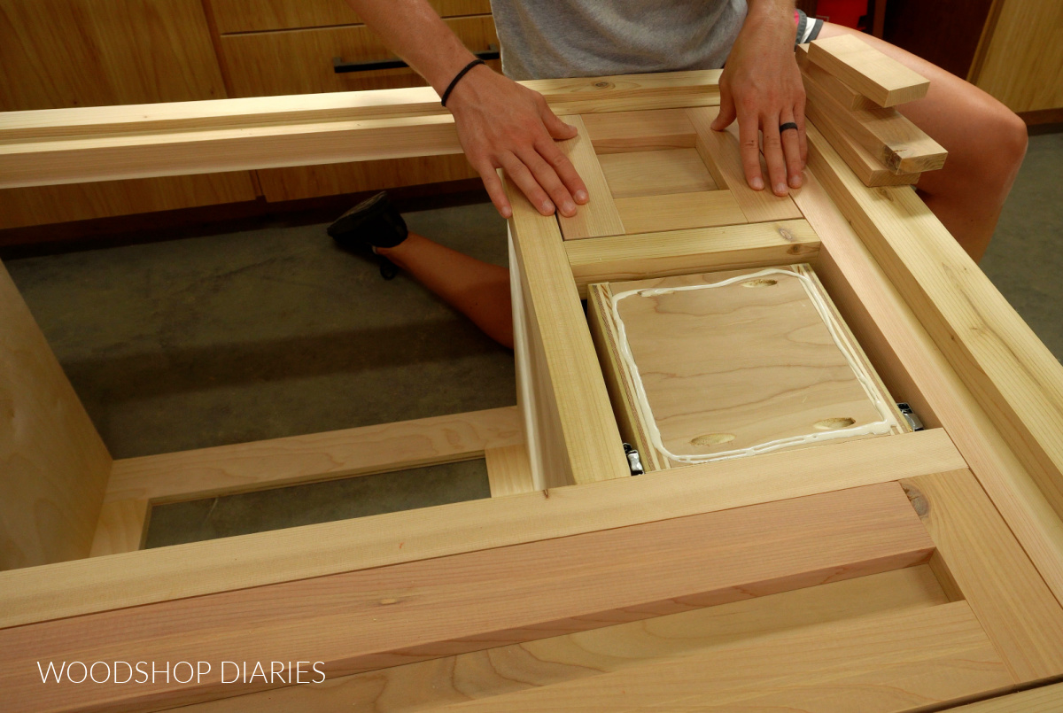 Shara Woodshop Diaries placing drawer front trim onto drawer boxes of vanity cabinet