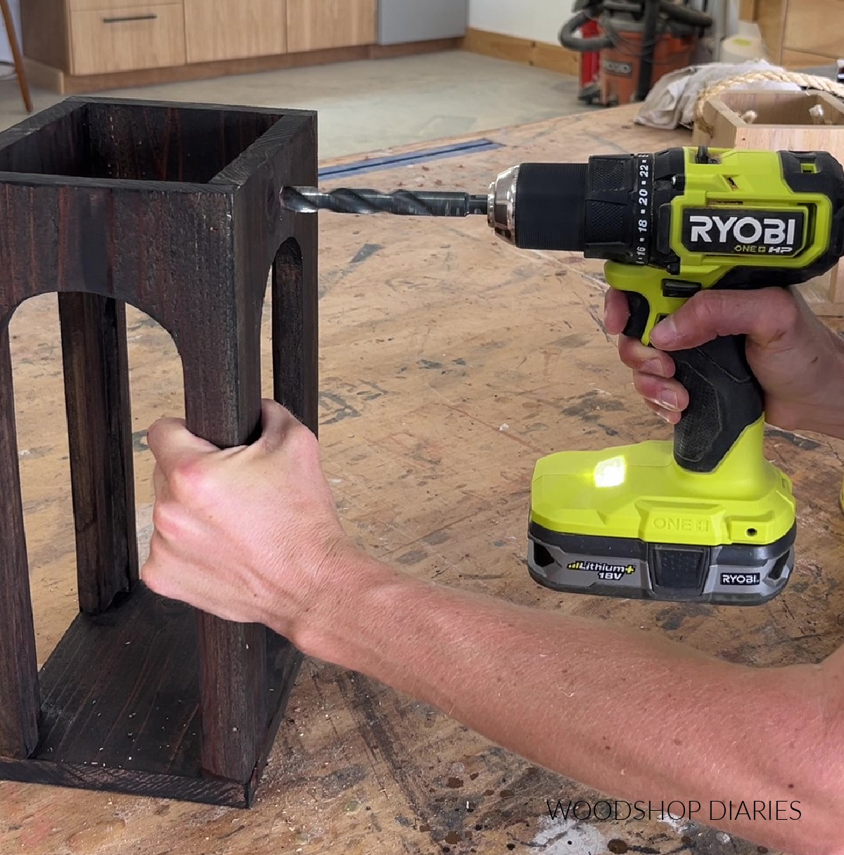 Drilling holes in scrap wood lantern for rope handle