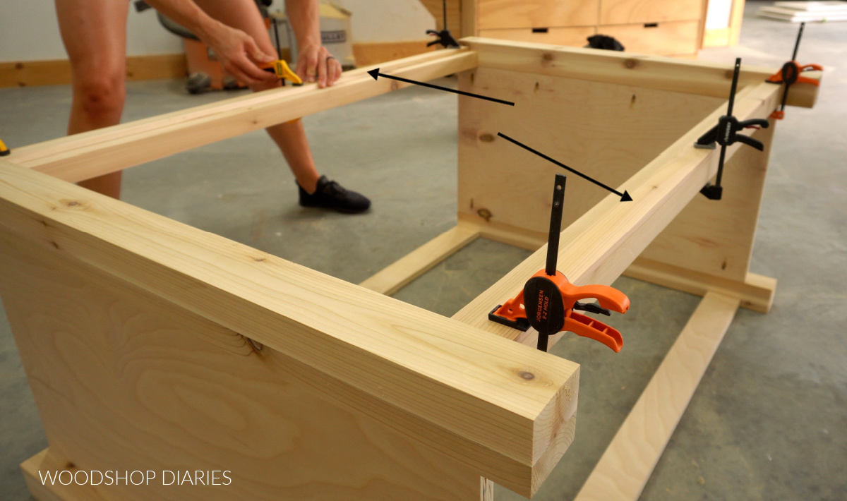 Close up of gluing lattice trim onto front of vanity cabinet frame