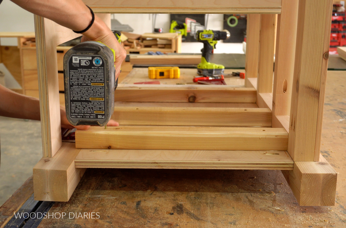 Close up of Shara Woodshop Diaries installing spacer blocks to side panels