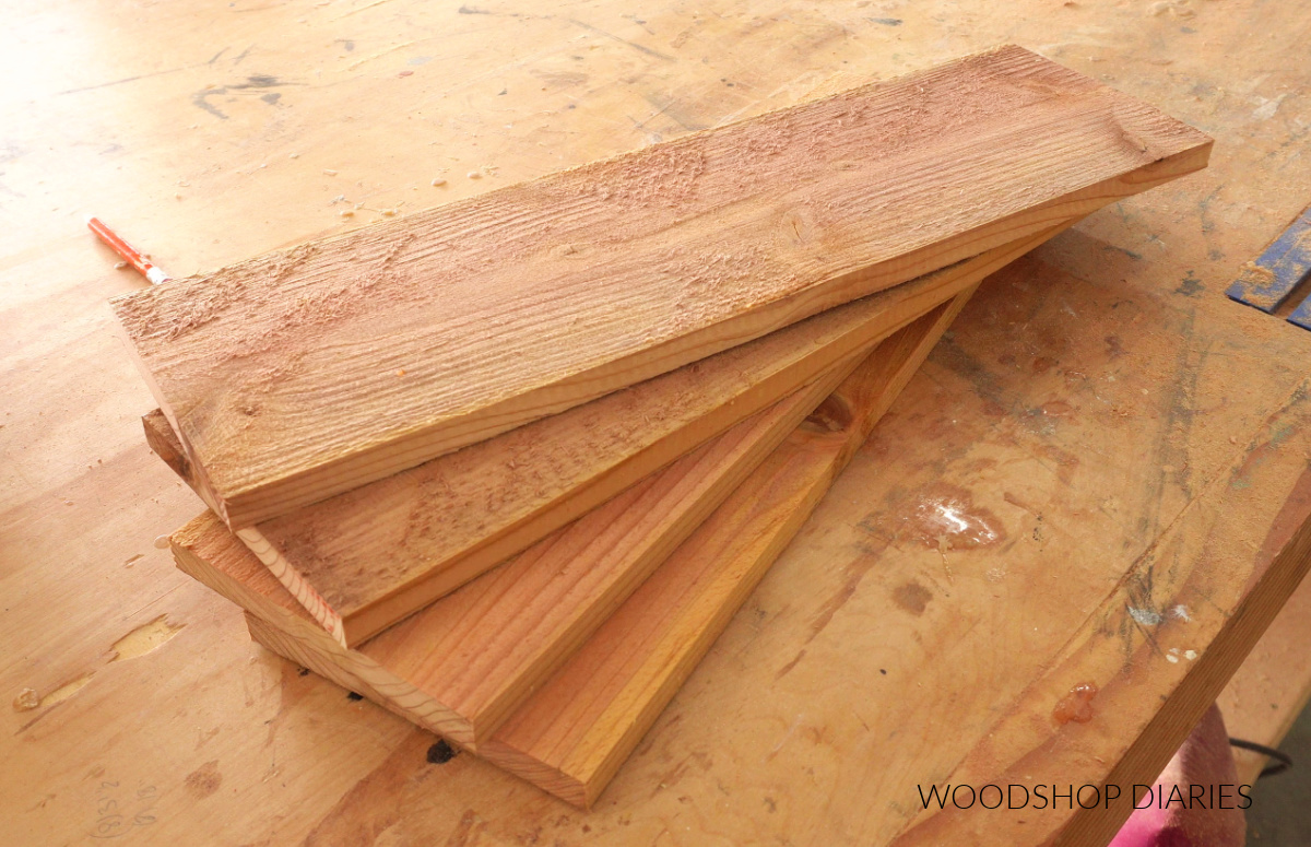 four cedar fence pickets laid out on workbench