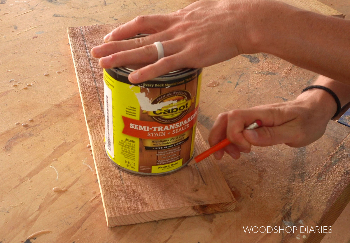 Using a stain can to trace an arch on lantern board on workbench