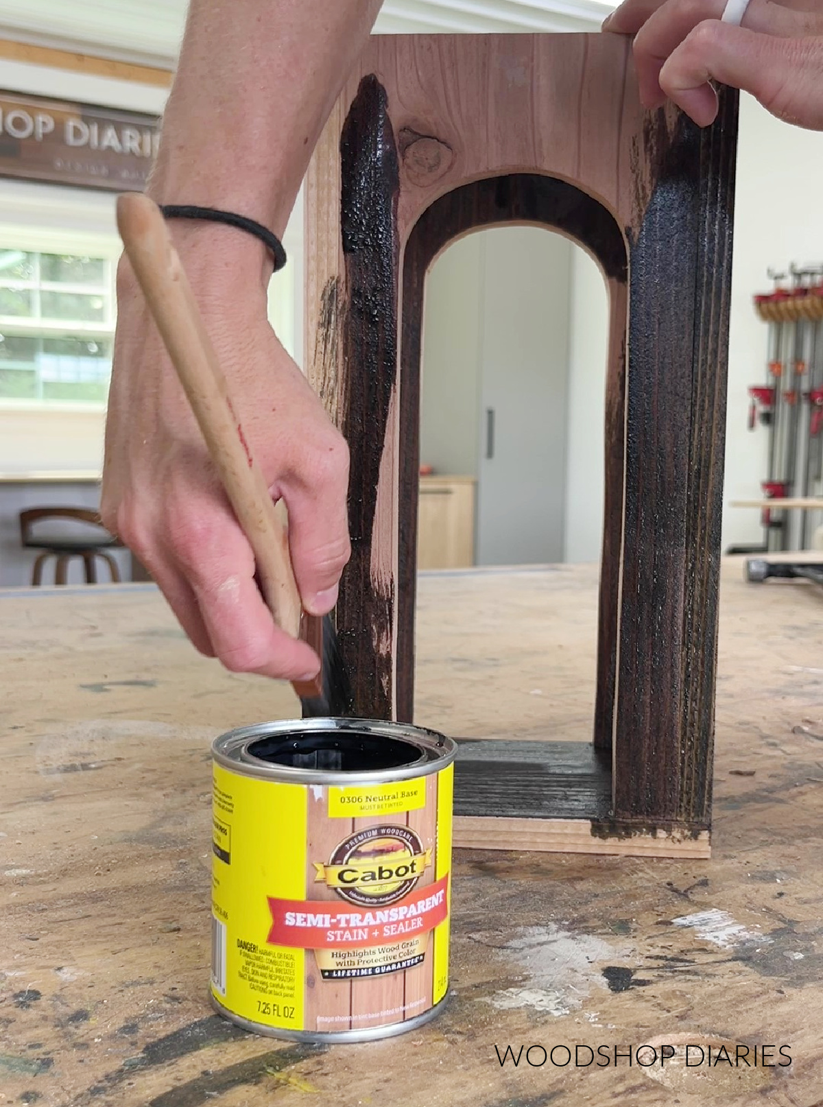 Staining scrap wood lantern on workbench
