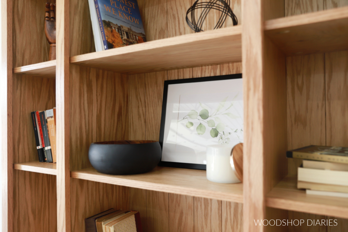 Close up of bookcase with books and decor on shelves