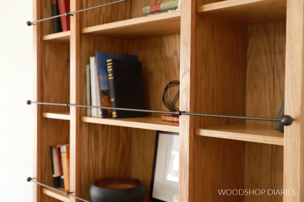Close up of gallery railing above shelf in bookcase--railing in front of books