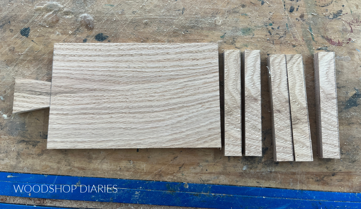 DIY drink coaster tray pieces cut and laid out on workbench