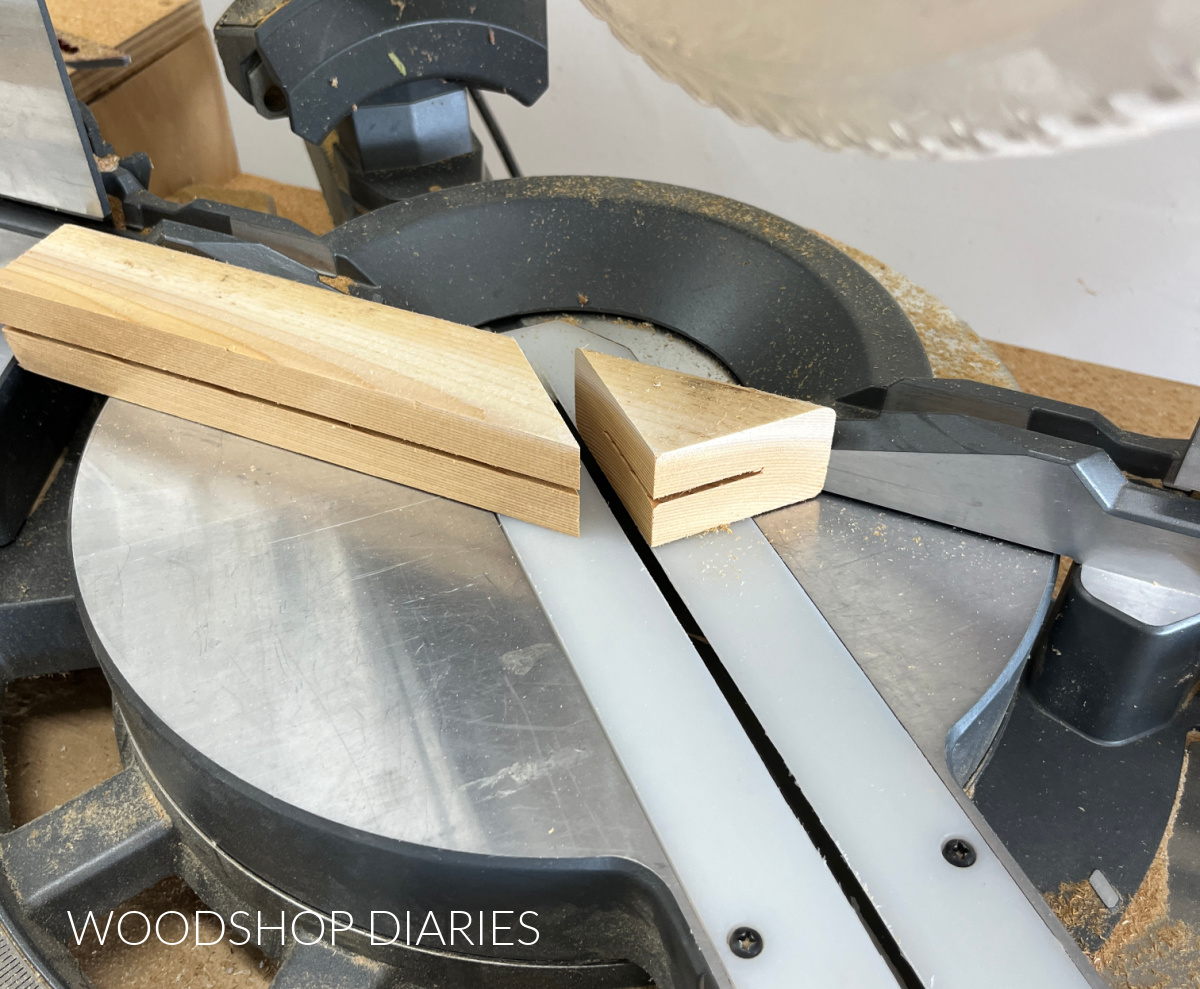 Board being cut in miter saw