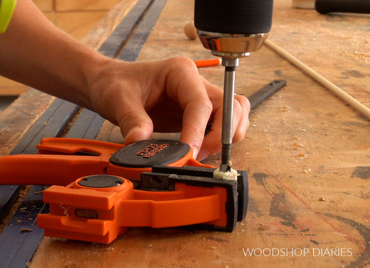 Drilling ¼" hole through ½" dowel on workbench