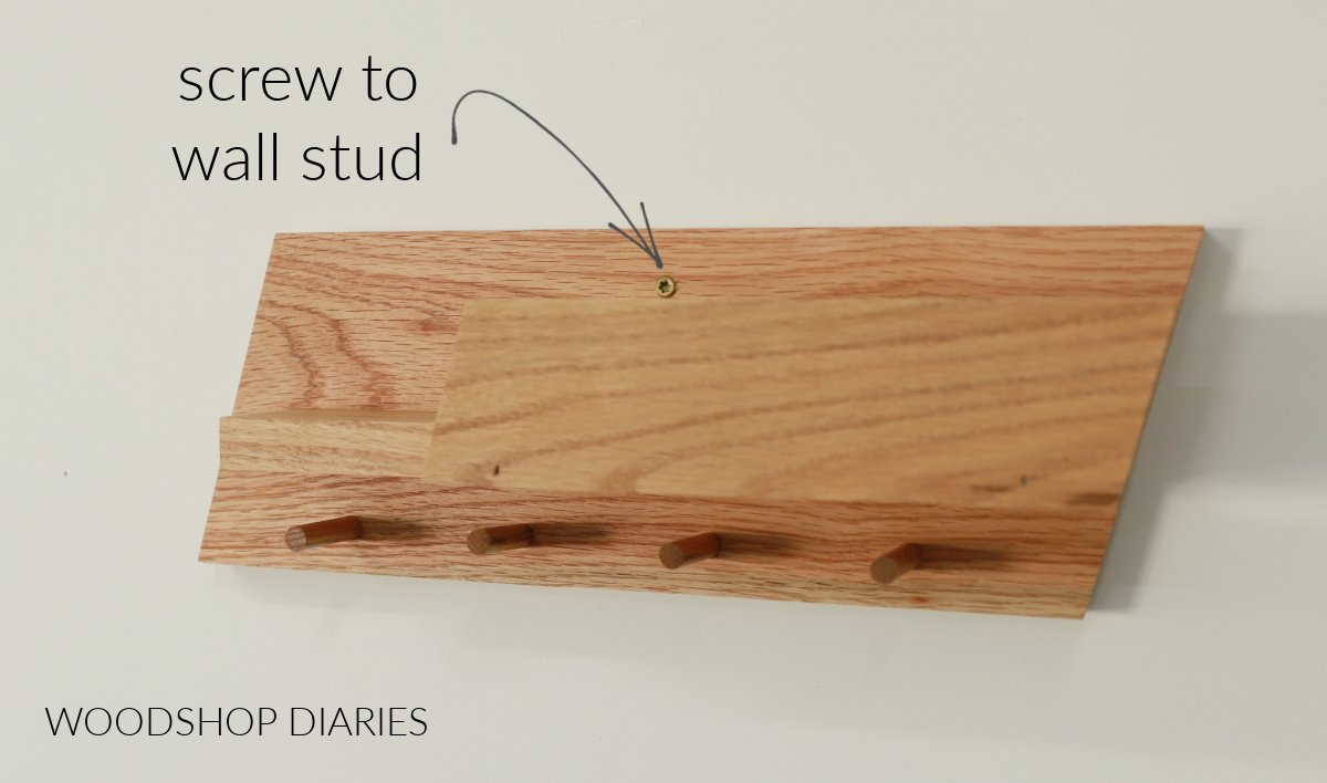 scrap wood entryway shelf installed to stud using a screw