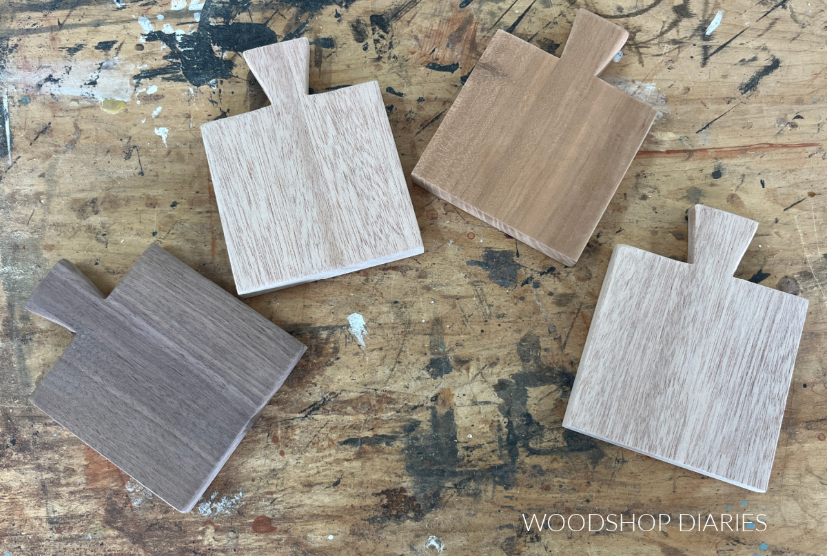 four different wood coasters cut and sanded spread out on workbench