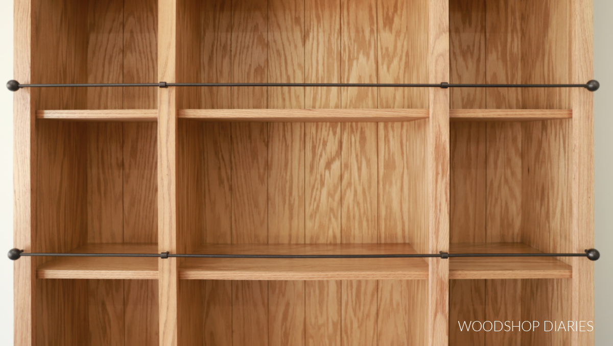 Empty bookshelf with gallery rails running in front of shelves