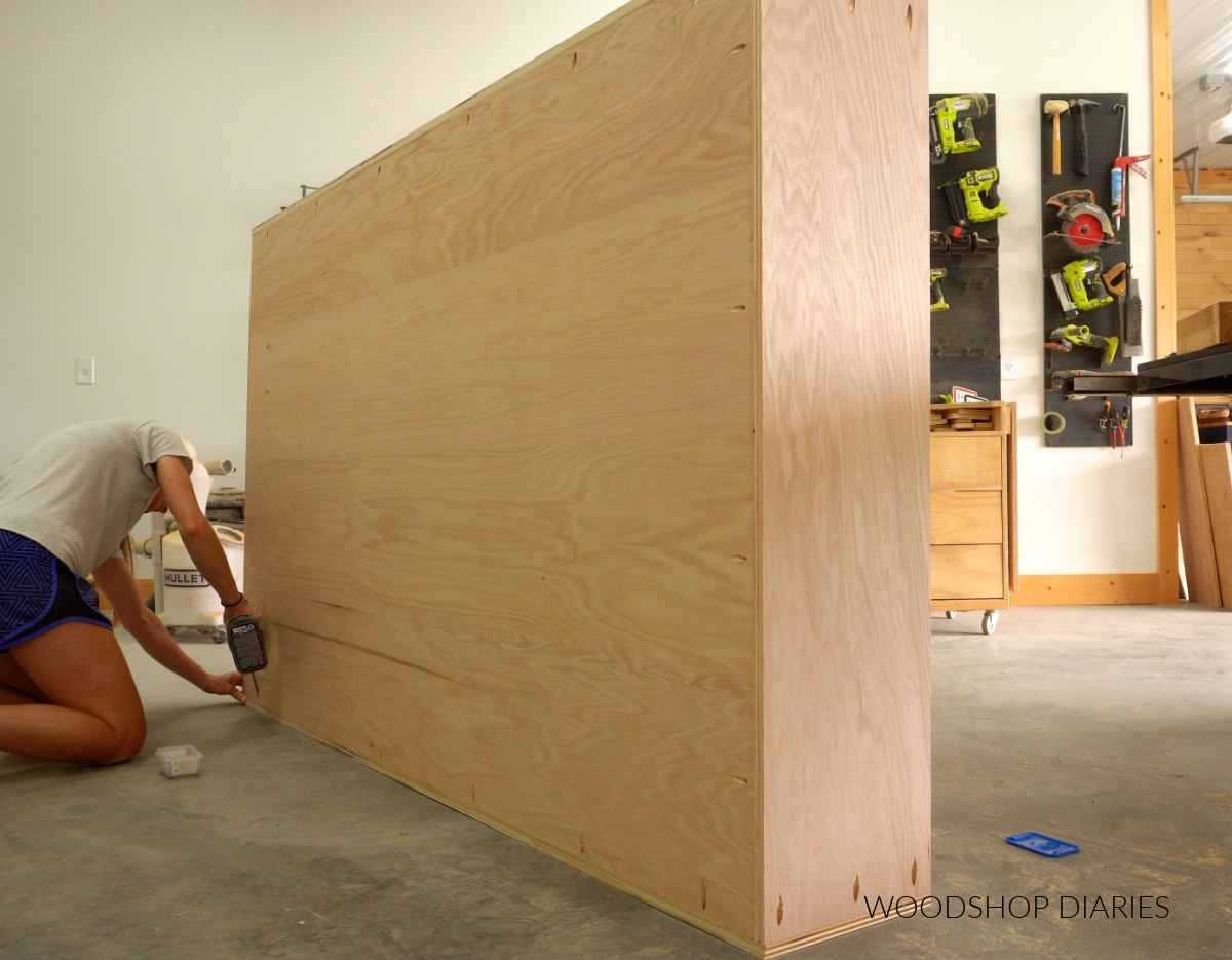 Shara Woodshop Diaries installing back panel of bookcase with pocket hole screws