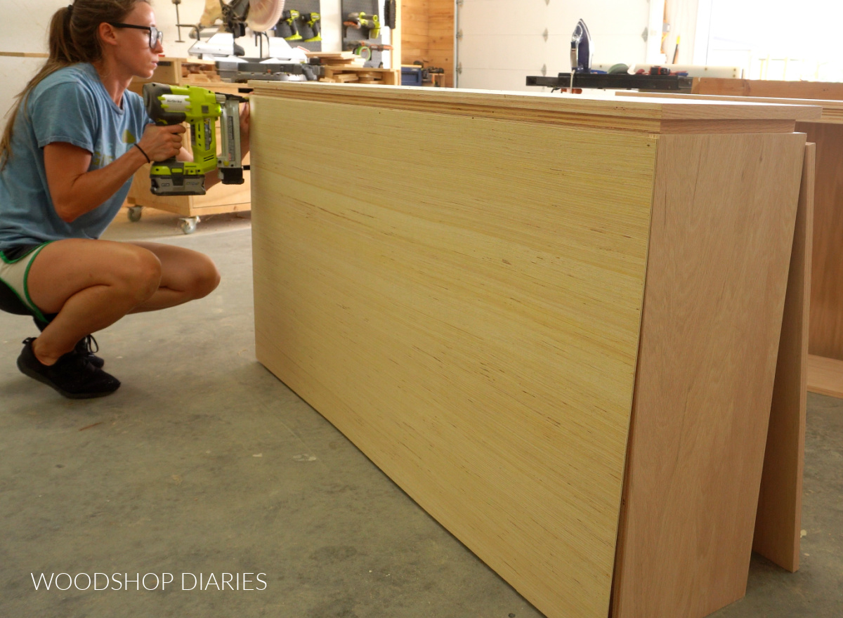 Shara Woodshop Diaries stapling back panel onto cabinet box
