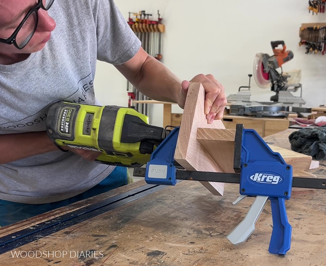 Shara Woodshop Diaries nailing shelf onto back panel of key holder shelf