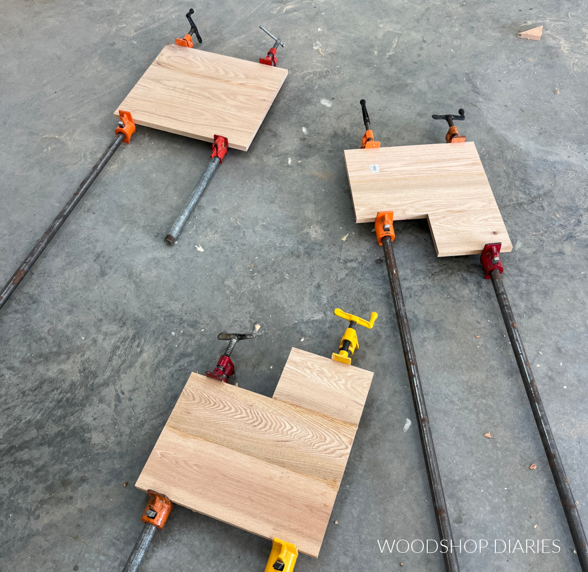 Three red oak 1x6 glued up panels on the concrete shop floor
