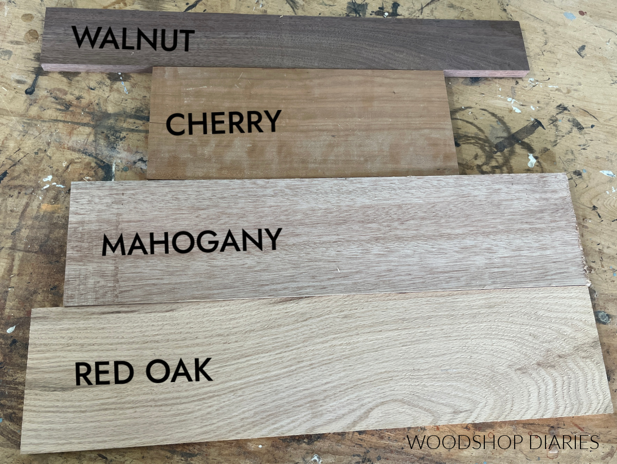 different types of wood on workbench--walnut, cherry, mahogany, red oak