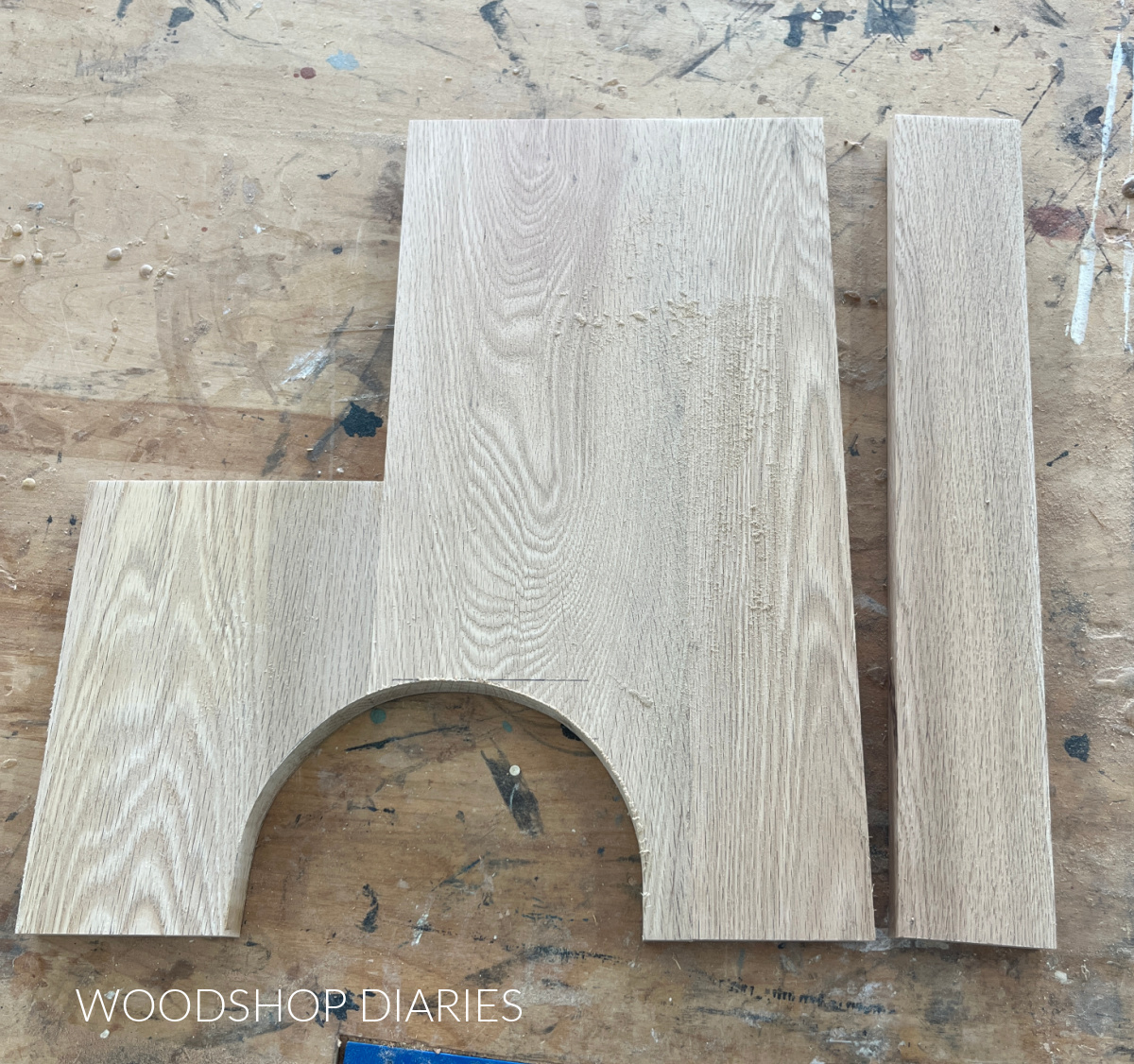 Side panels of plant stand with strip cut off back edge and arched cut out at bottom