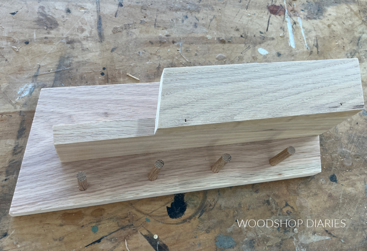 wooden pegs installed on wall shelf organizer